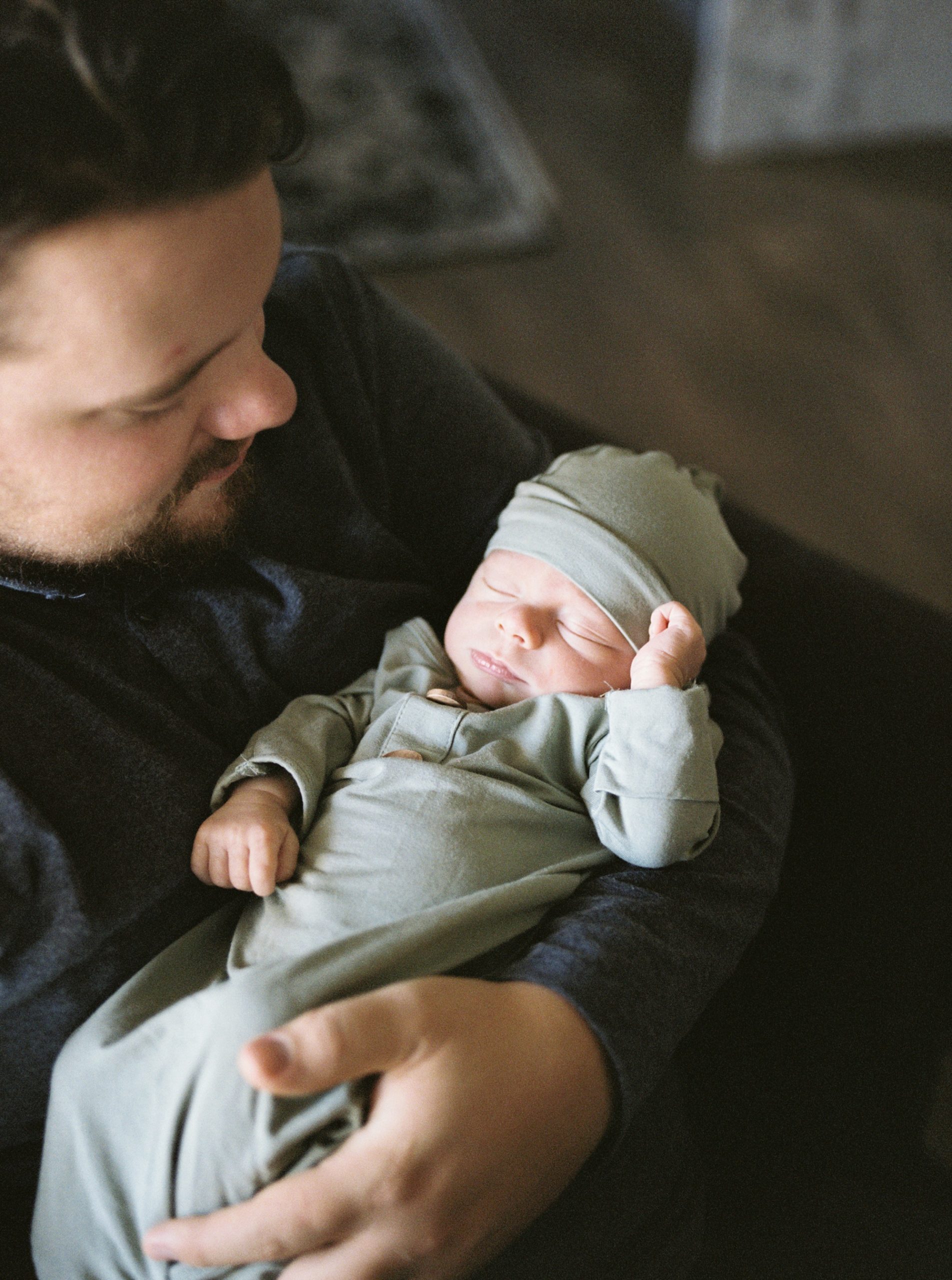 dad holds baby boy during In Home Lifestyle Newborn