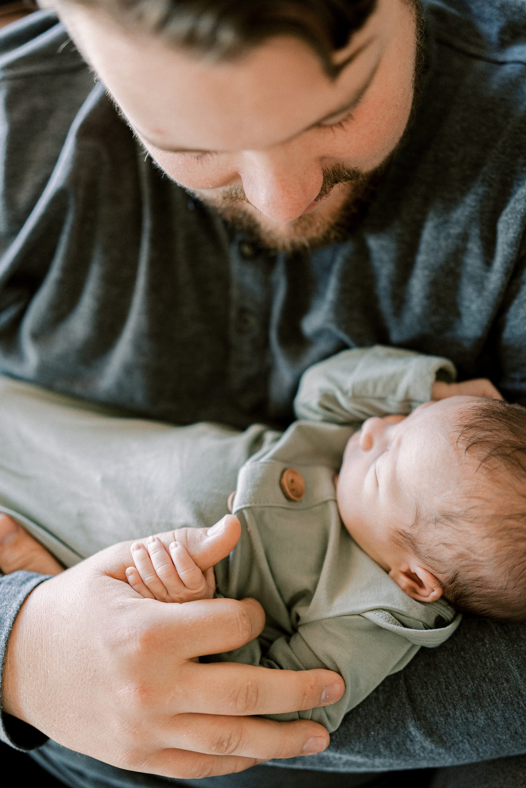 dad holds baby boy during photos at home