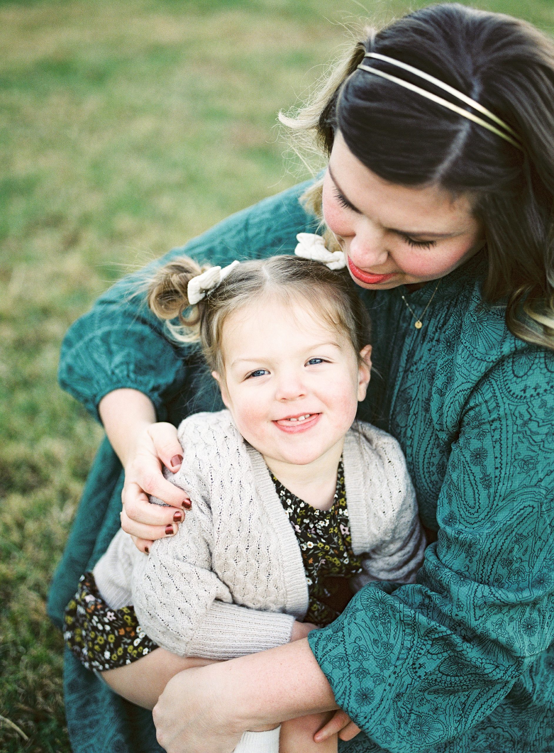 mom and daughter snuggle during fall family photos
