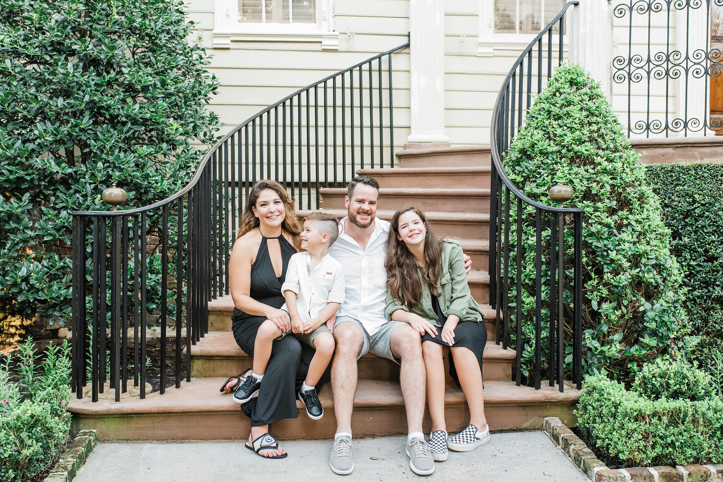 family laughs on steps in Downtown Charleston SC