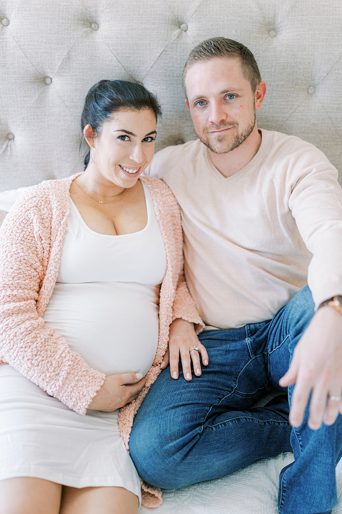 parents sit on bed at home during Murfreesboro lifestyle maternity session