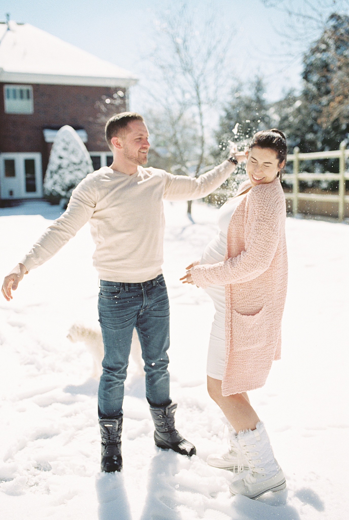couple has snowball fight during maternity photos in Tennessee snow