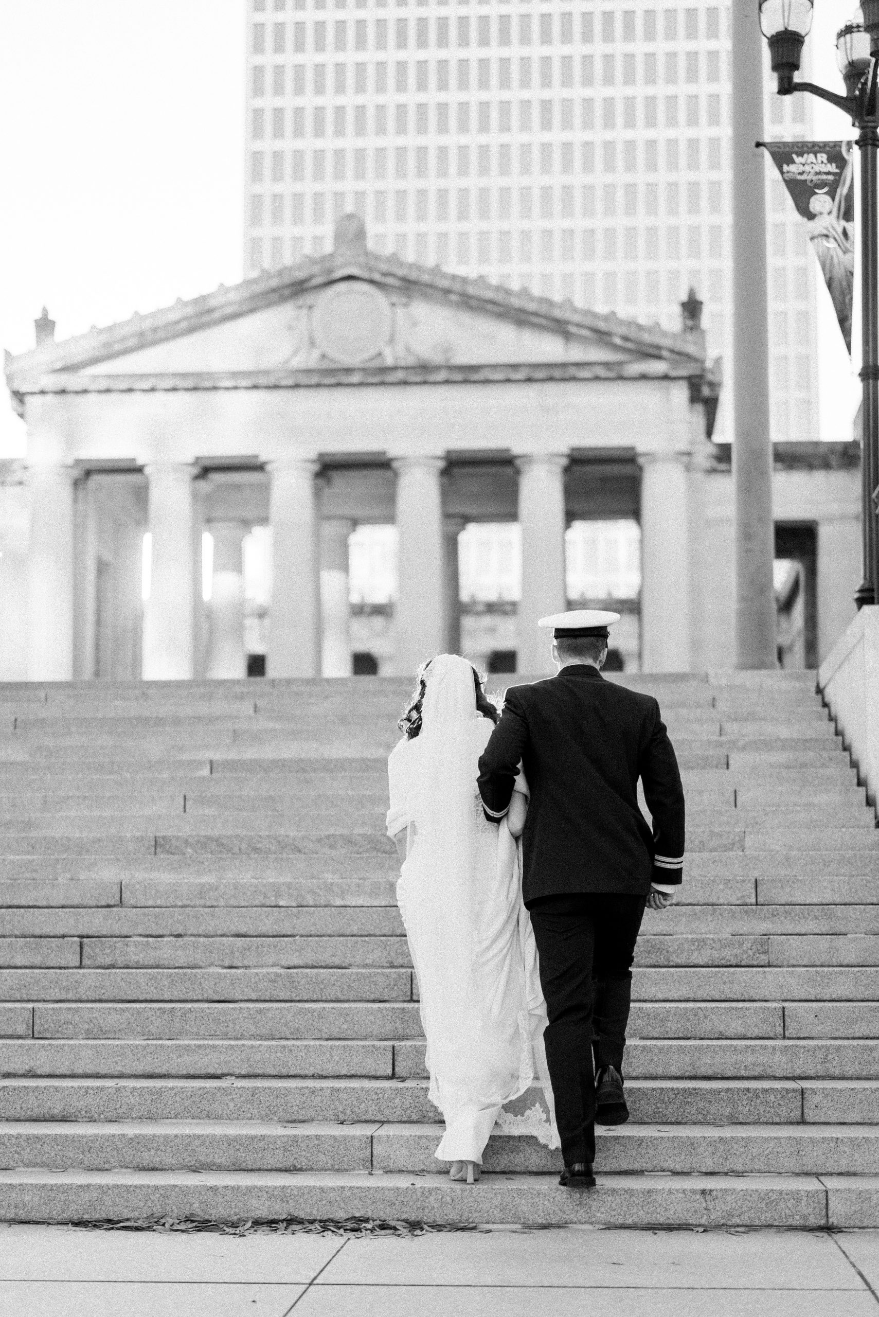 groom help bride up steps in Downtown Nashville