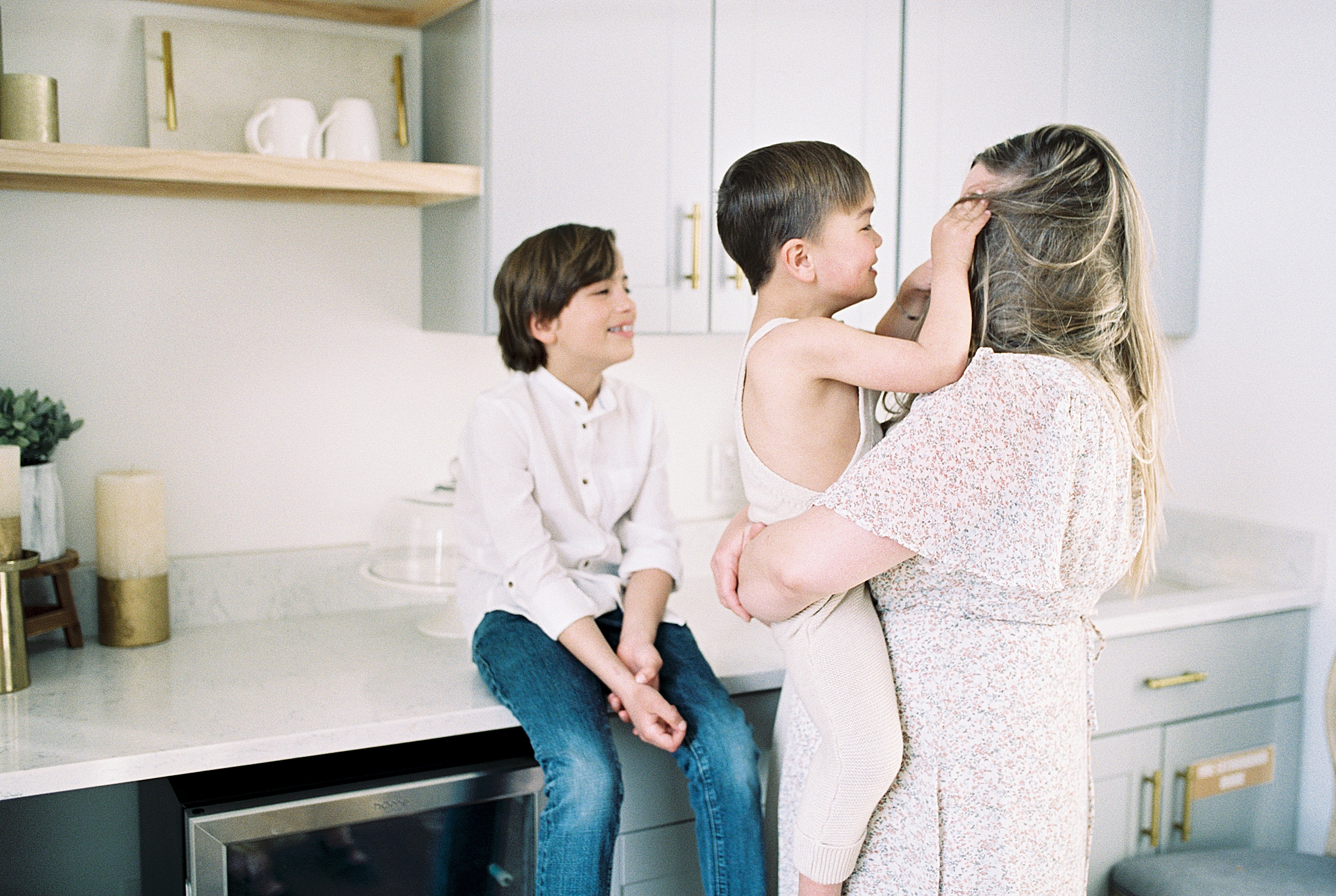 mom holds son in kitchen during photo session