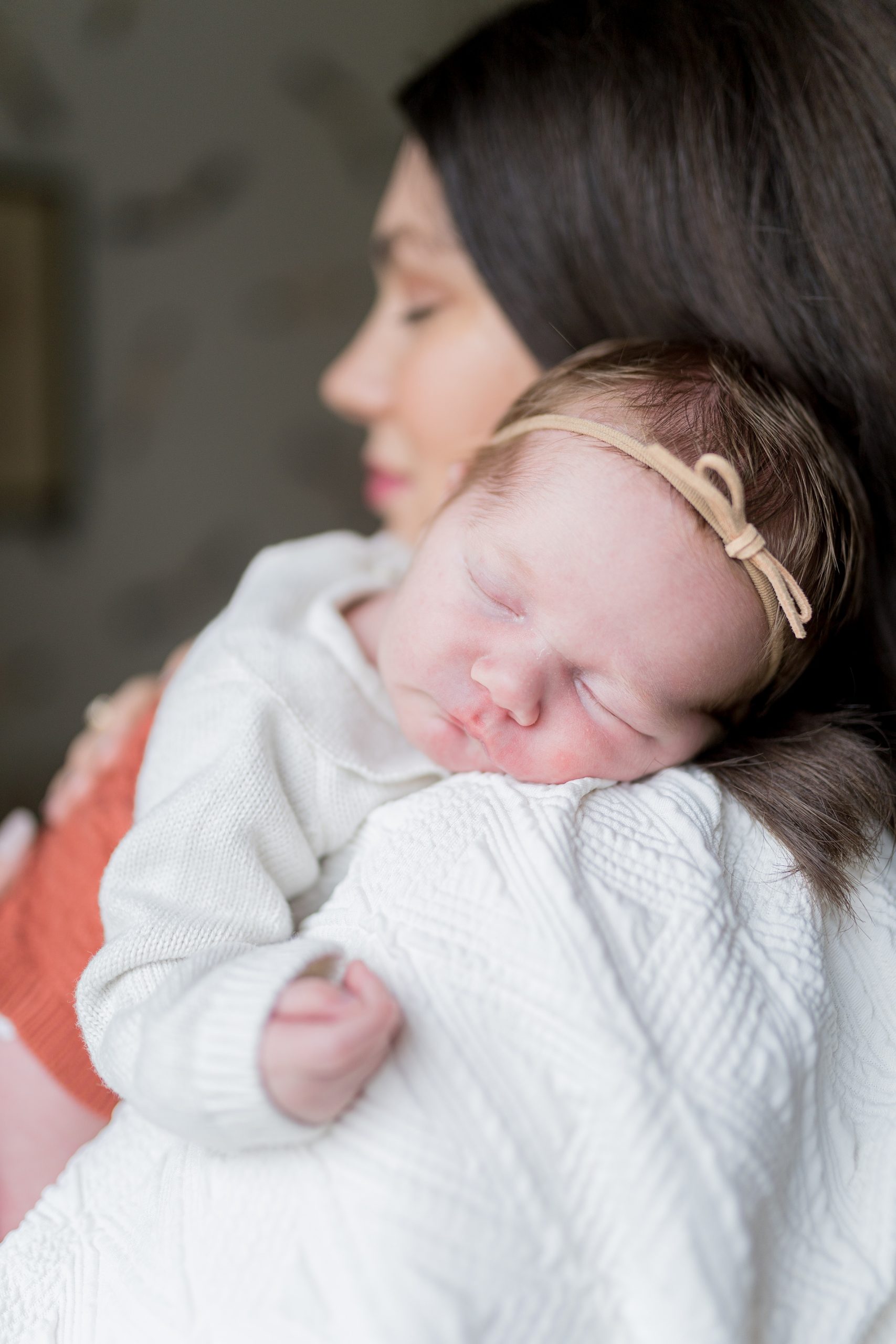 baby sleeps on mom's shoulder during Nashville lifestyle newborn portrait session