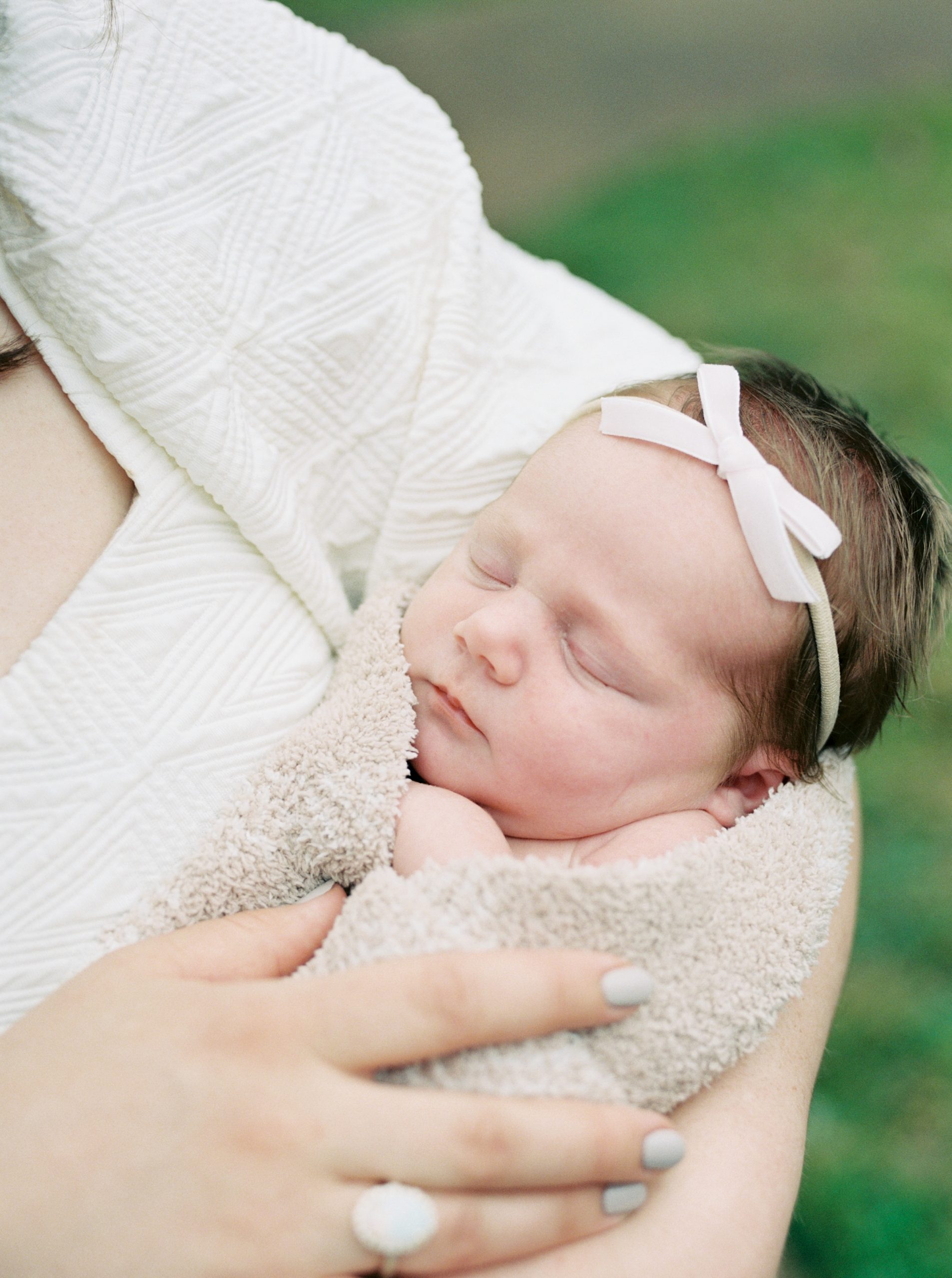 baby girl sleeps in mom's arms during TN newborn photos