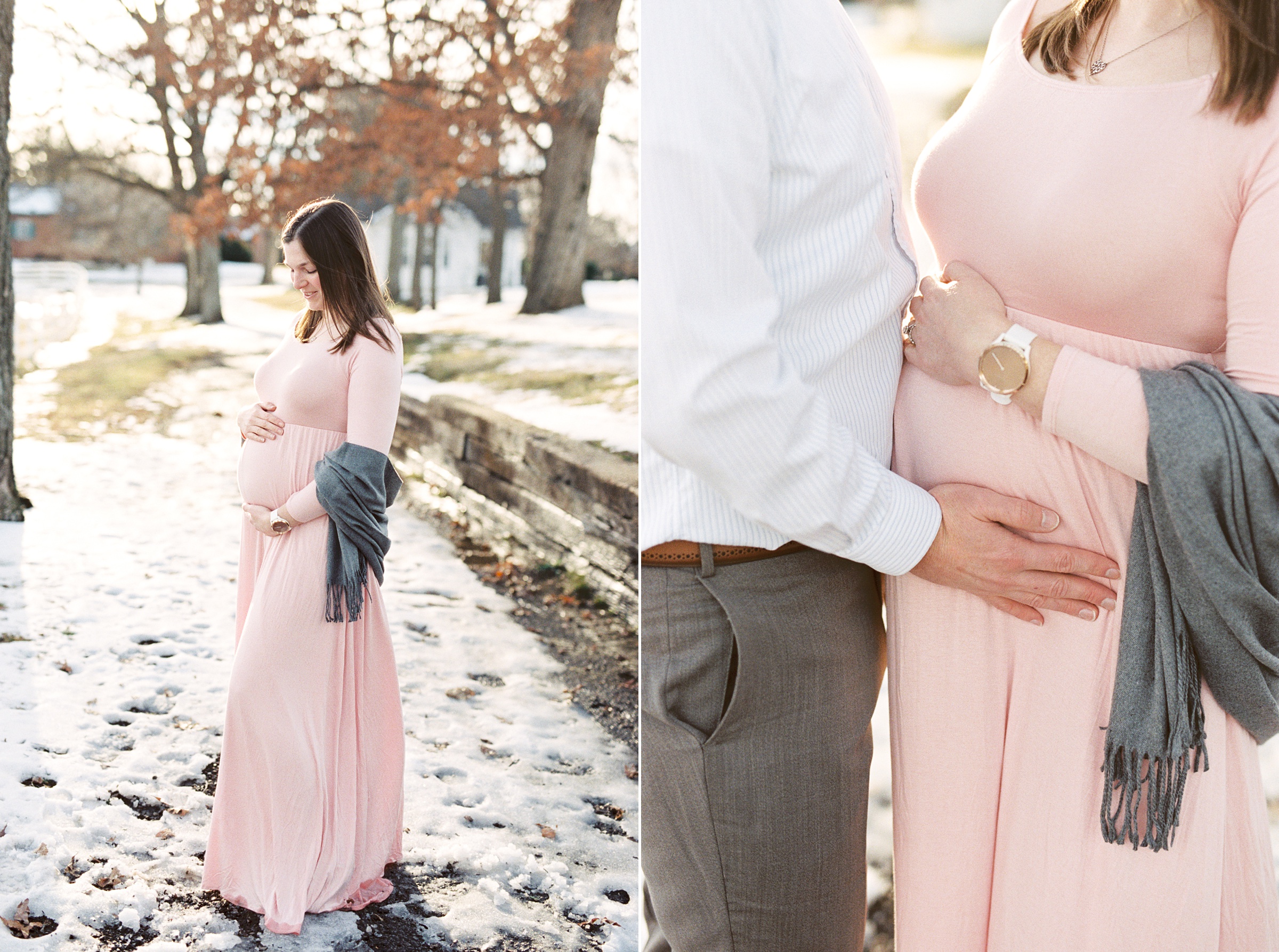 mother in pink gown holds belly during snowy maternity session