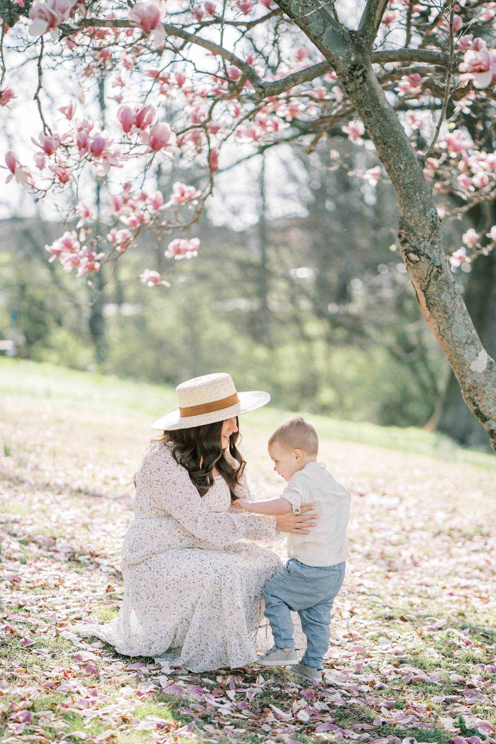 mom and toddler play under cherry blossom tree in Nashville TN