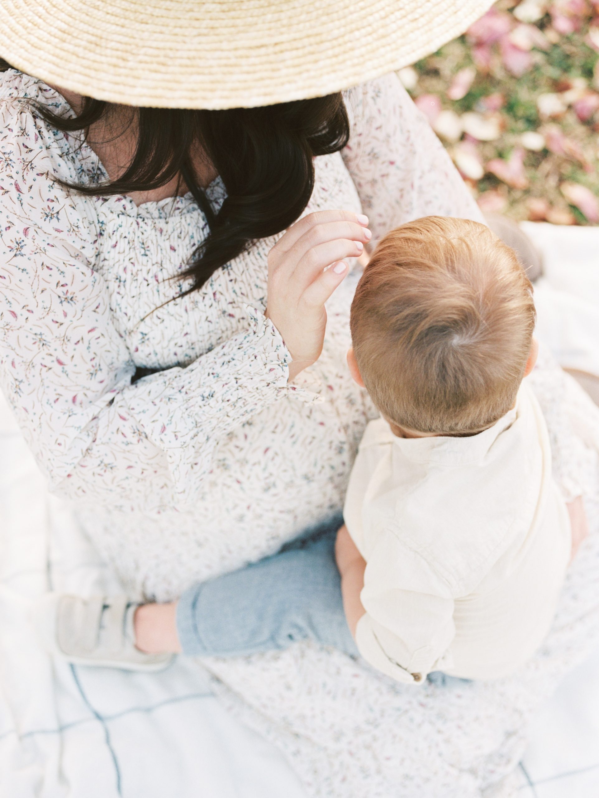 mom and toddler play during Nashville maternity photos in the spring