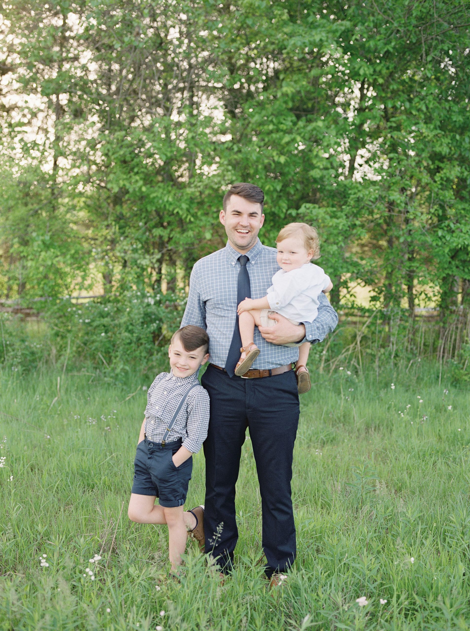 dad stands in field with his two sons during TN Family Session