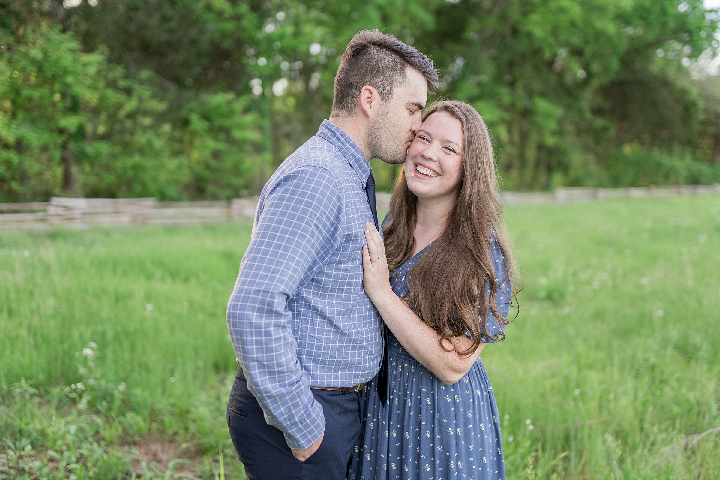 husband kisses wife's head during Stones River Battlefield Family Session