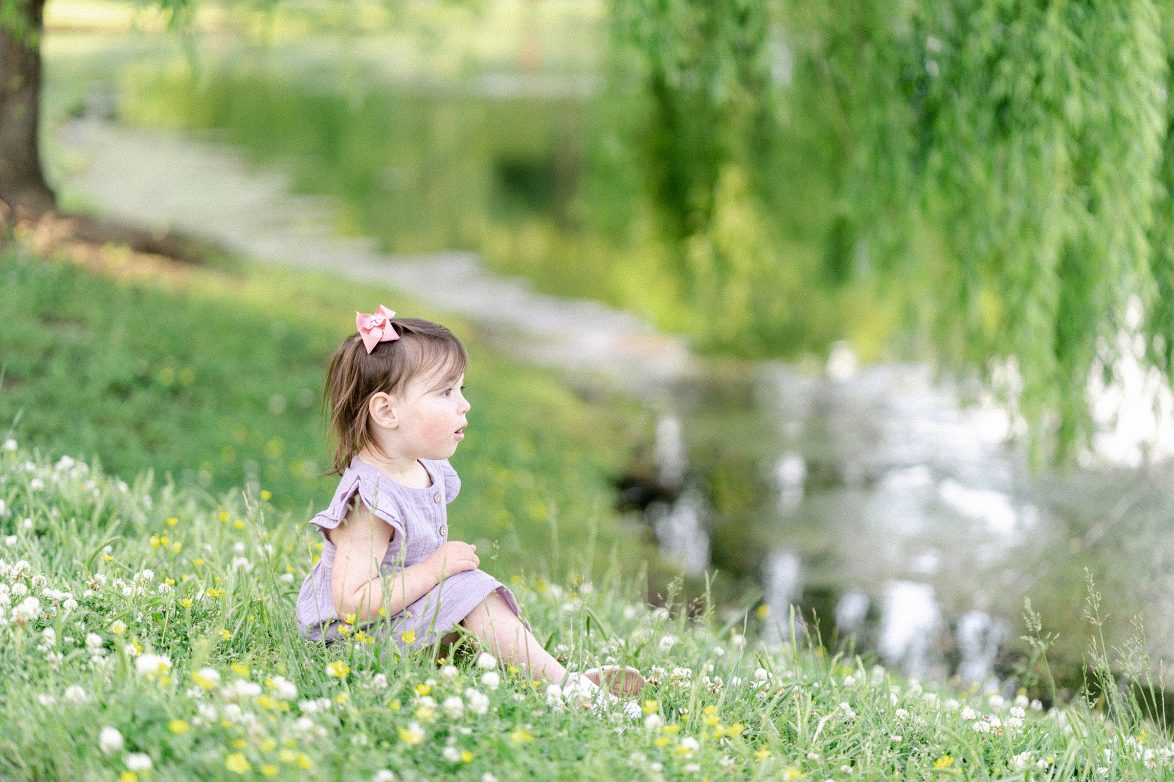 daughter sits by pond during TN family session
