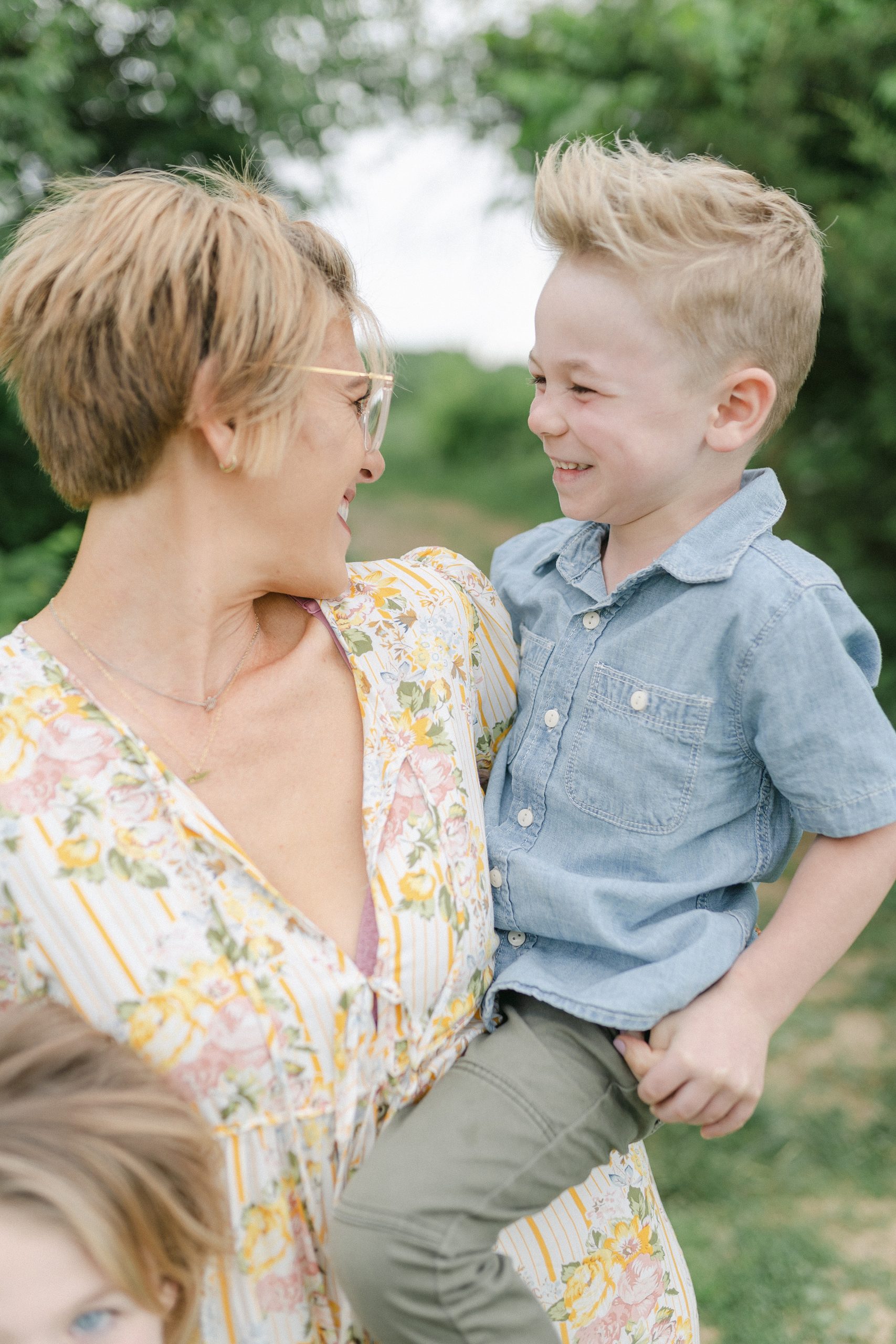 Mom holds son and the smile at each other during Brentwood Family Mini Session