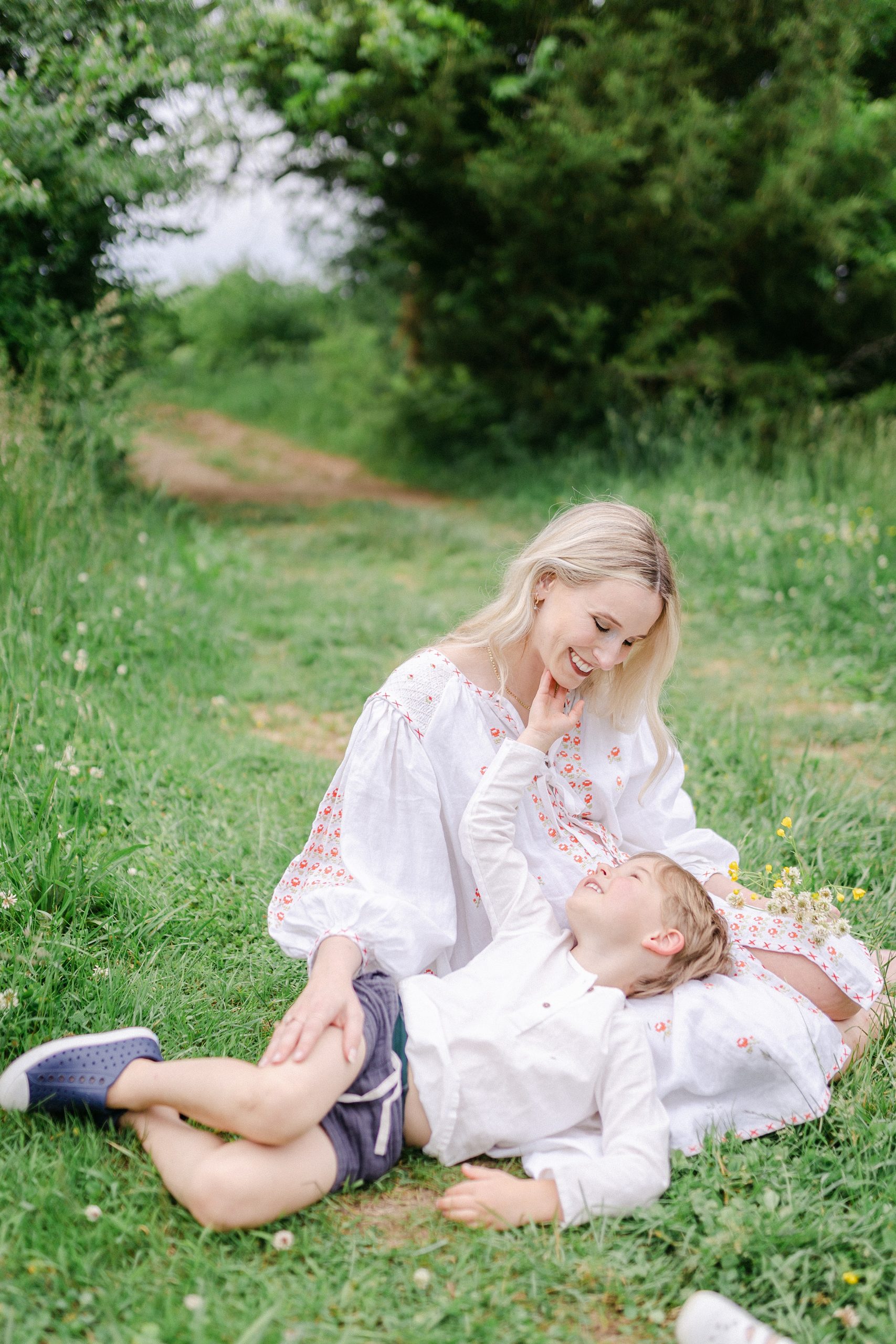 mom and son share tender moment sitting in grass in TN photos by Grace Paul Photography