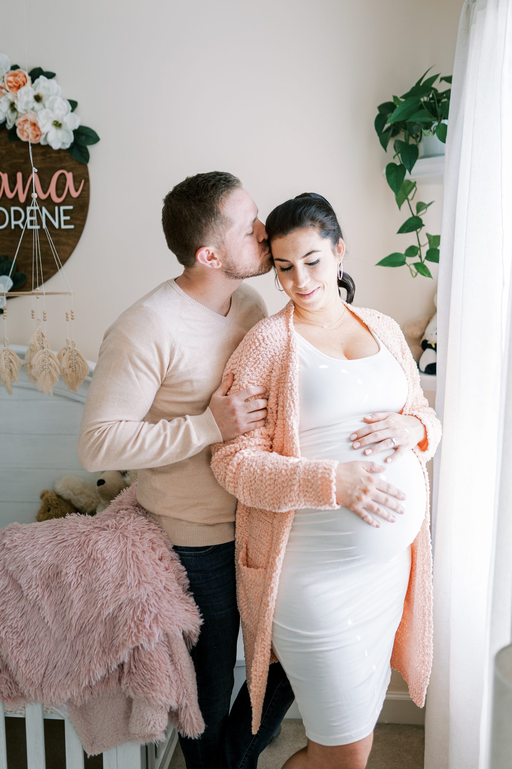 mom and dad in baby girls nursery during TN Maternity photos