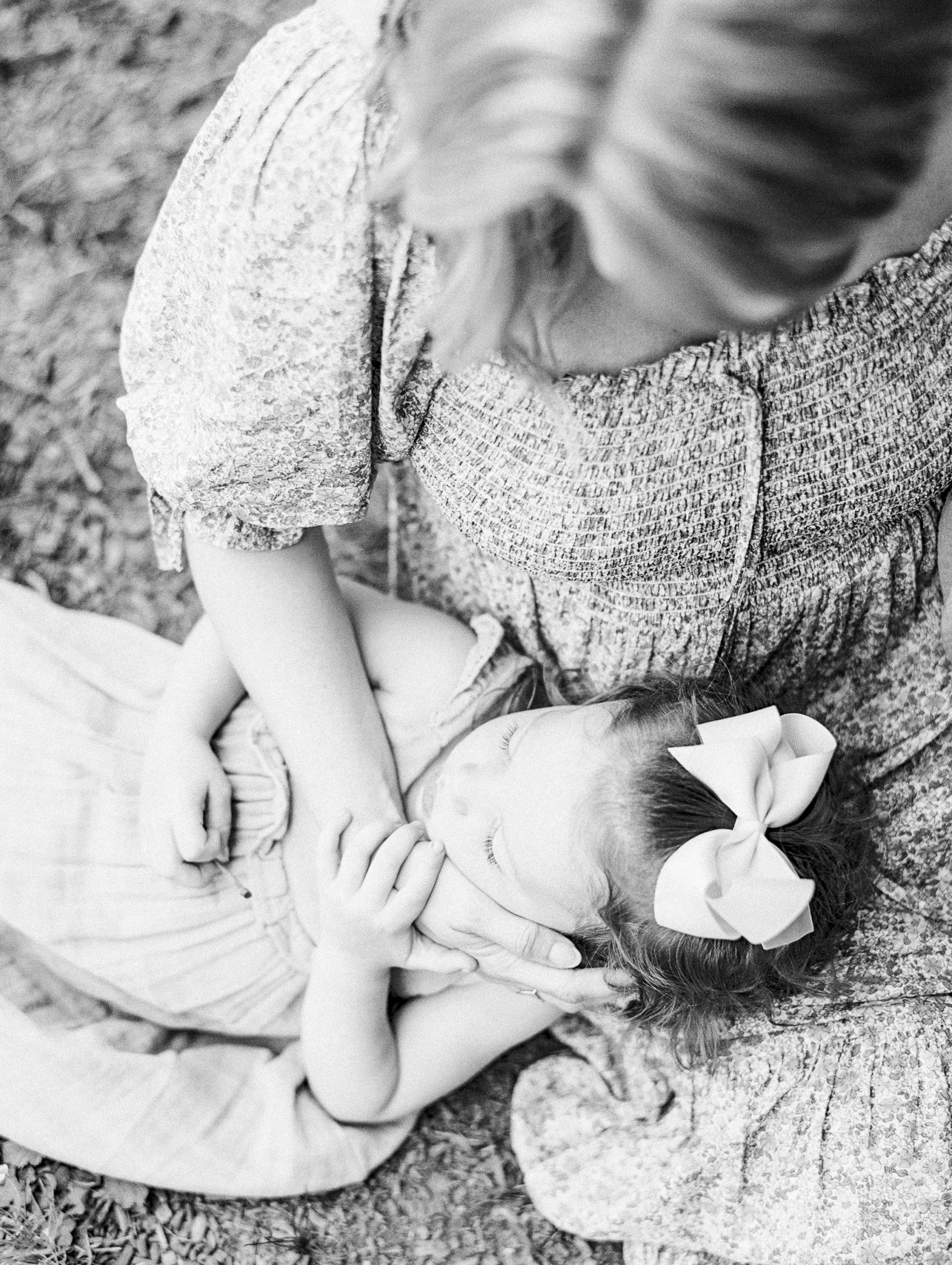 daughter snuggles up in mom's lap during TN portrait session