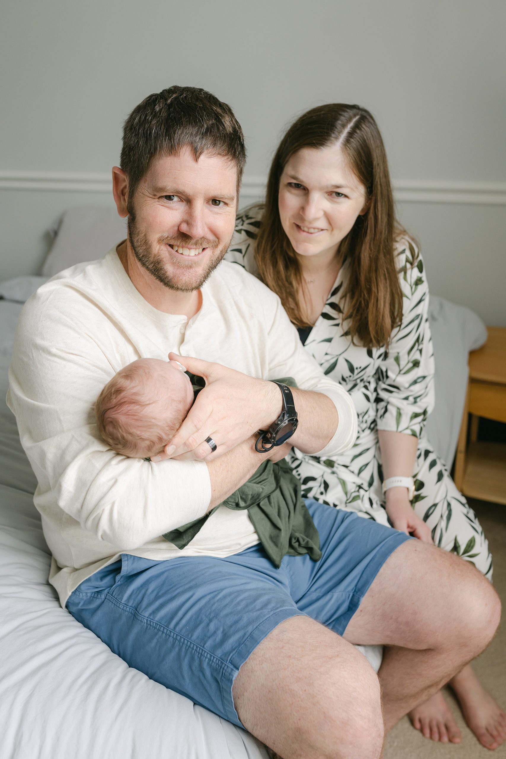 New parents hold son during lifestyle newborn session