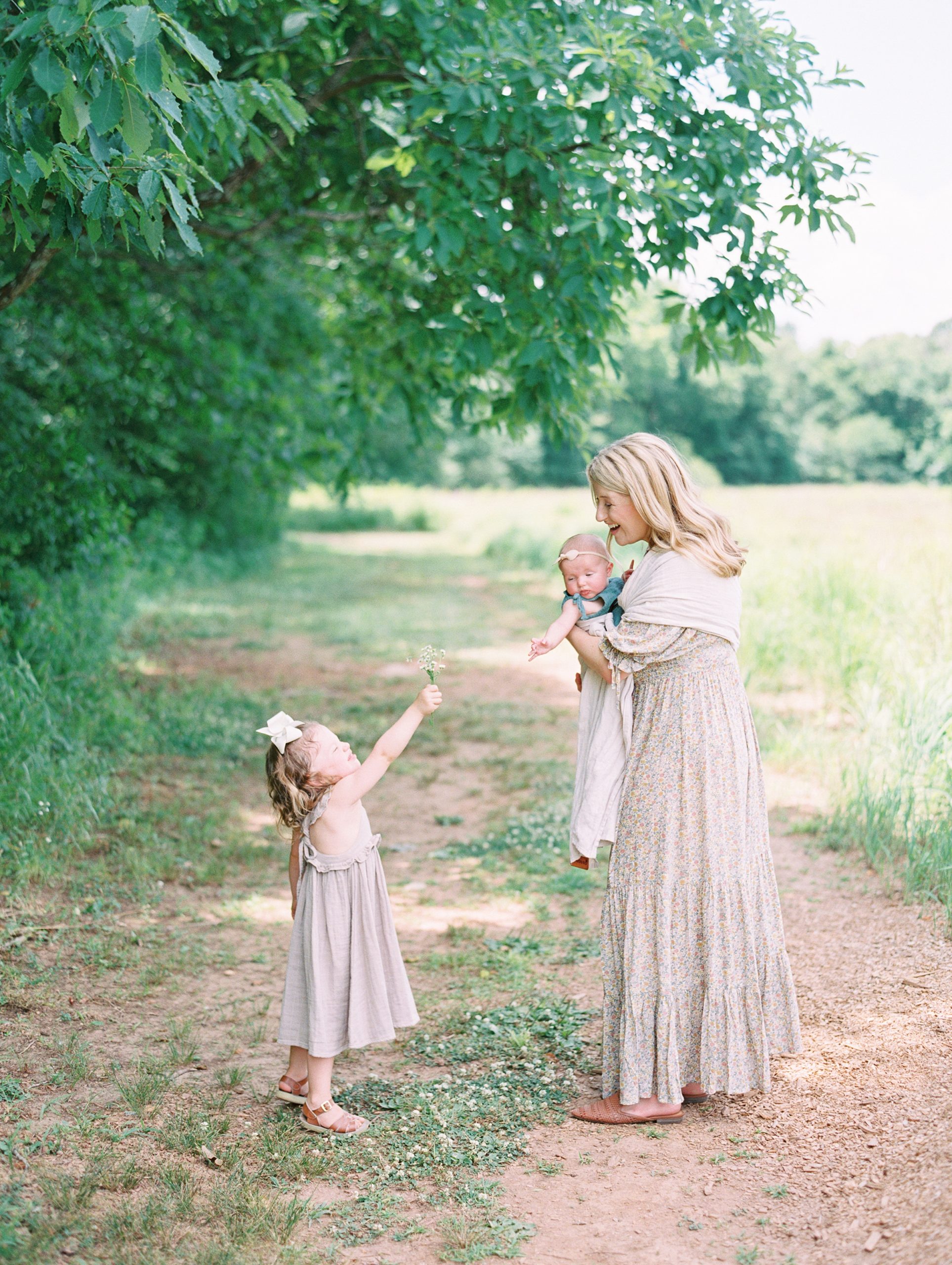 little girl hands mom a flower during Murfreesboro Tennessee Mom + Me Session