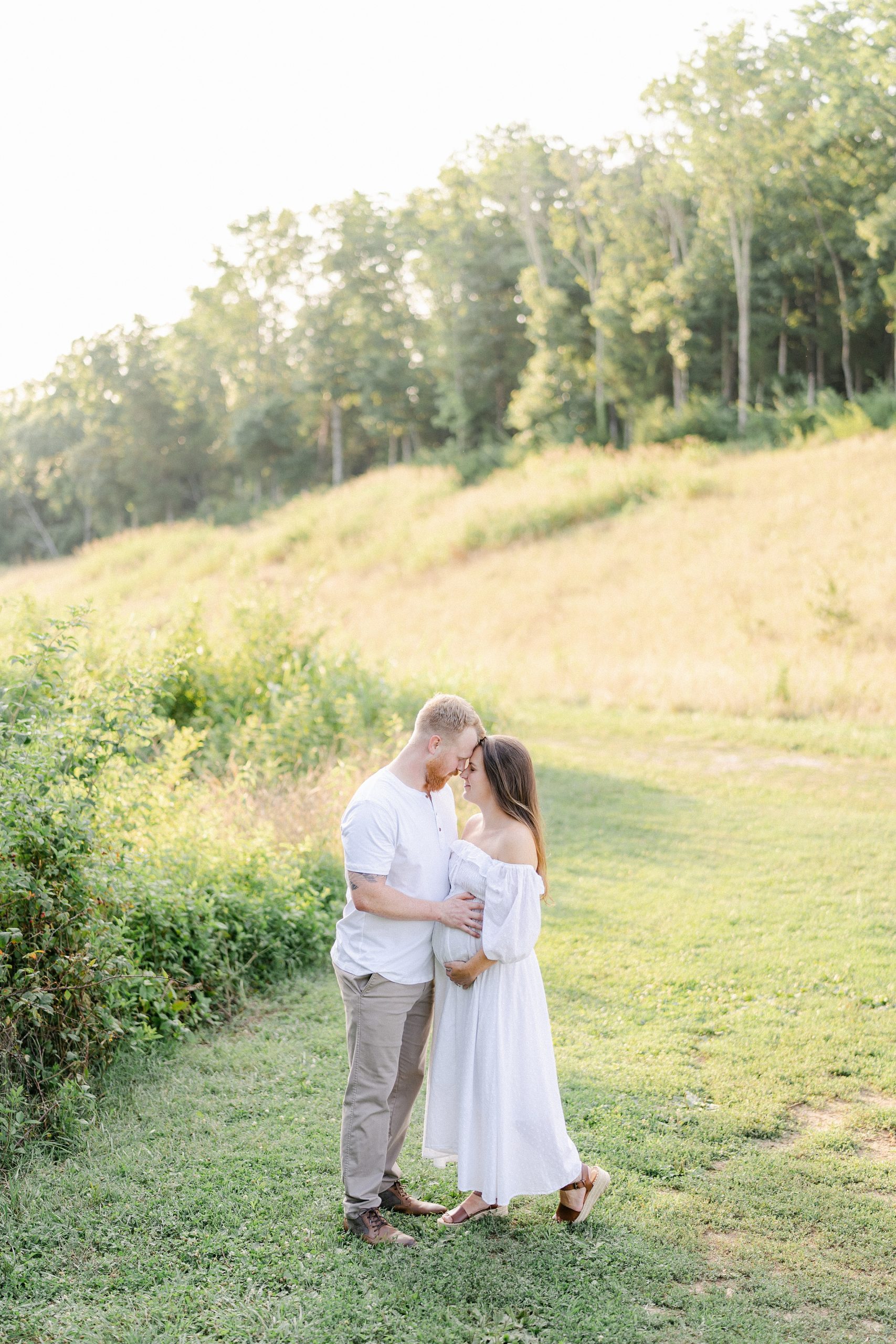 Couple in grass field during Brentwood, TN Maternity Session photographed by Grace Paul Photography