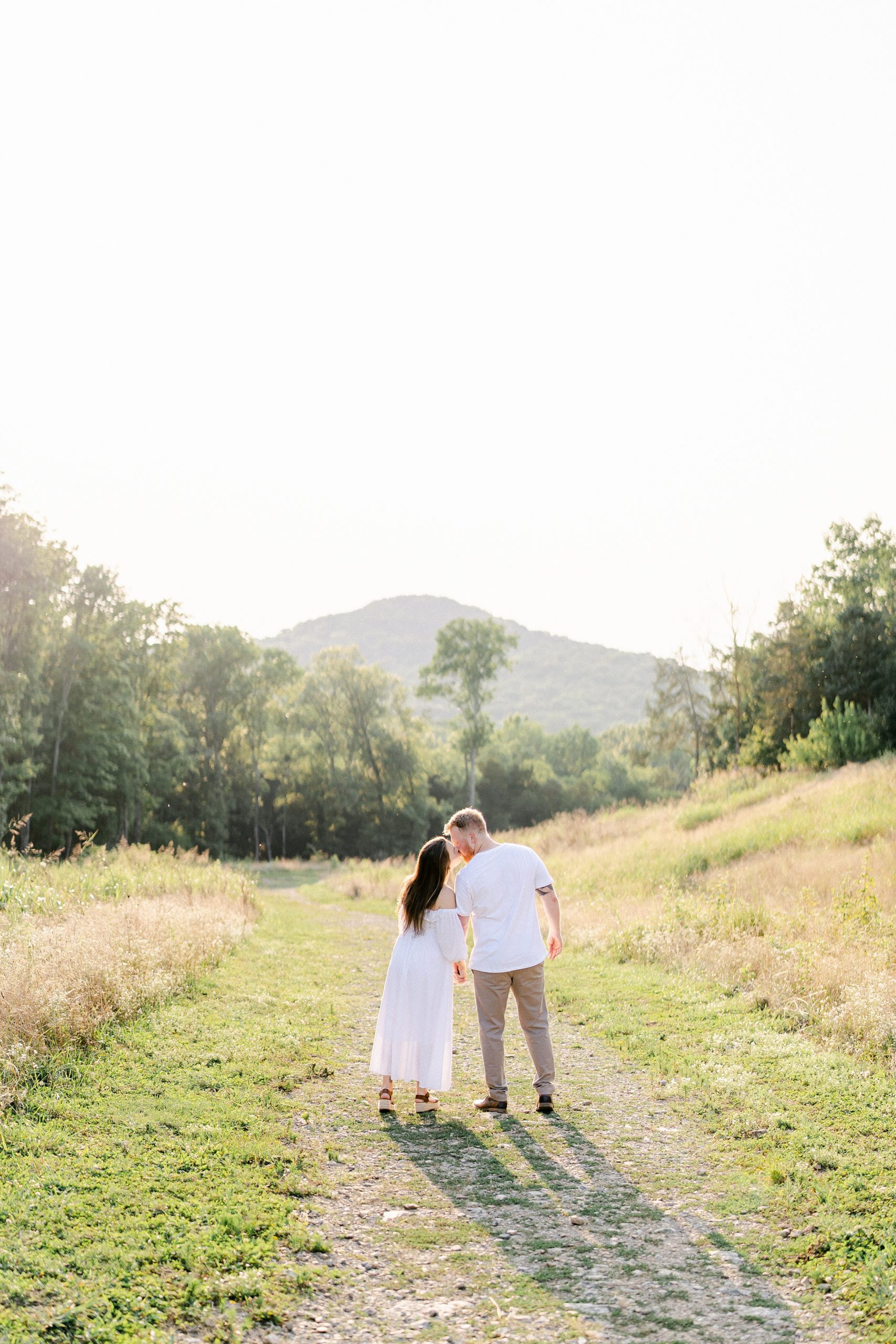 Husband + Wife hold hands as they walk during Brentwood TN Maternity Session by Grace Paul Photography