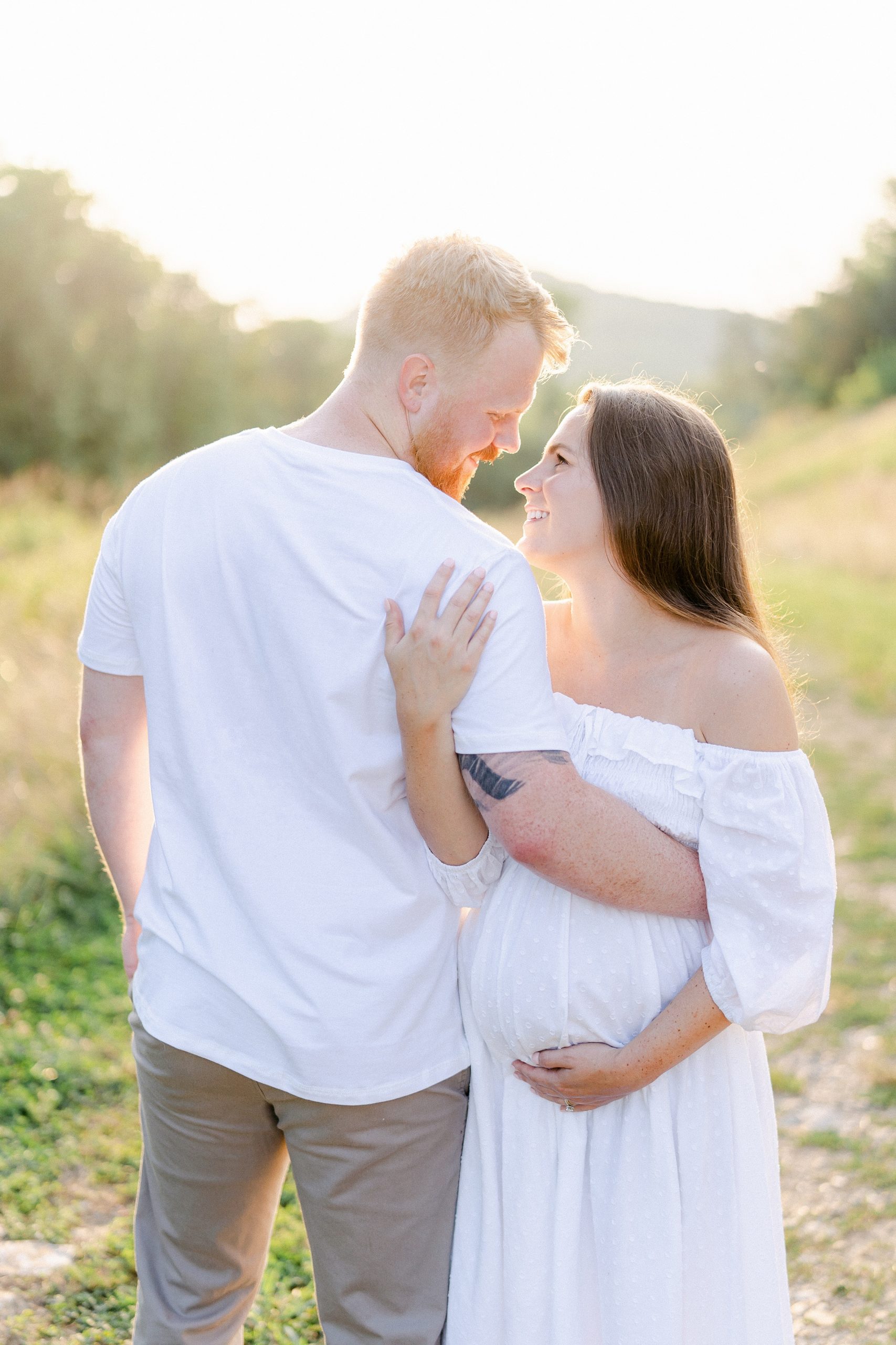 husband and wife link arms during their Brentwood TN Maternity Session by Grace Paul Photography