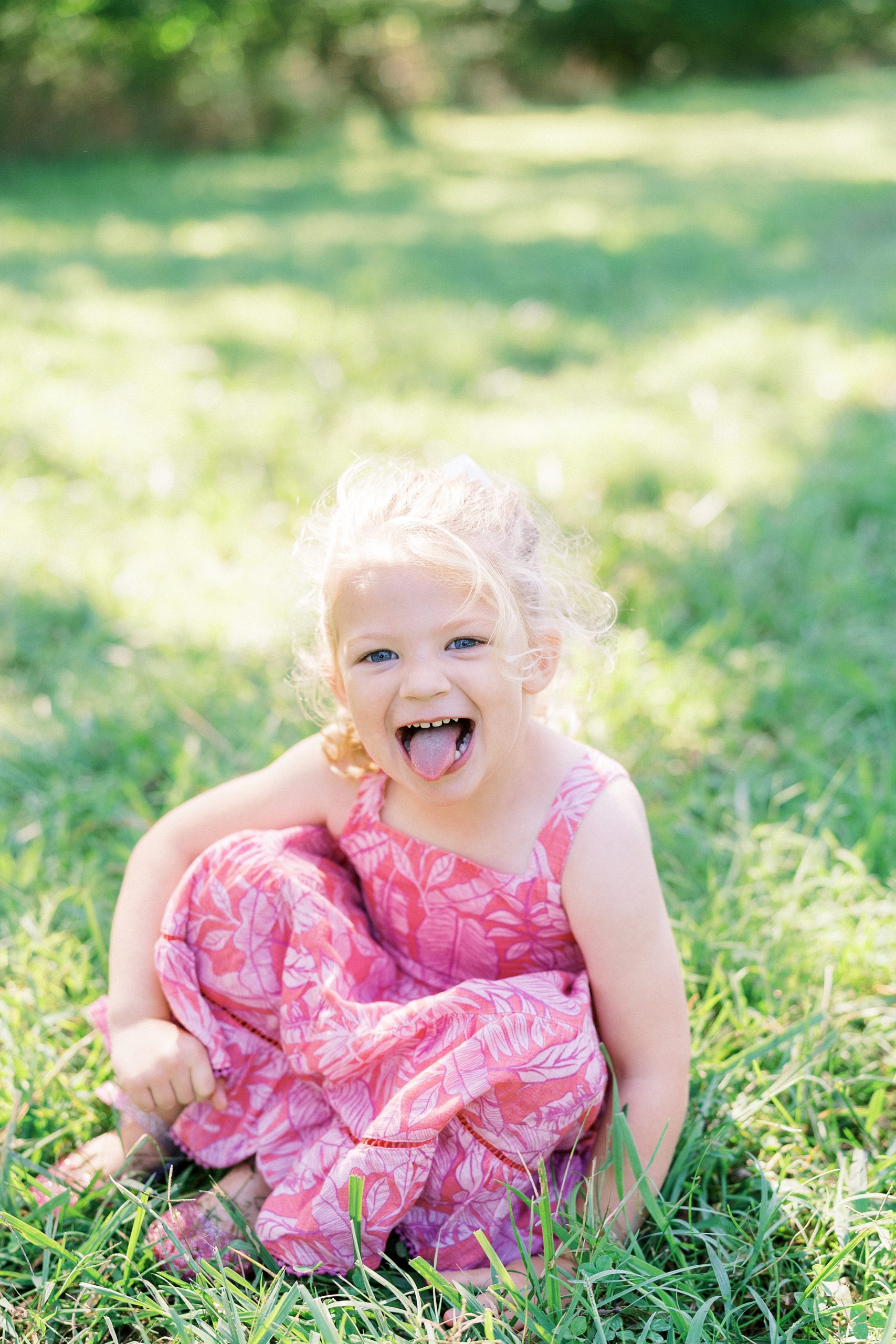 little girl showing off her silly side during family photos