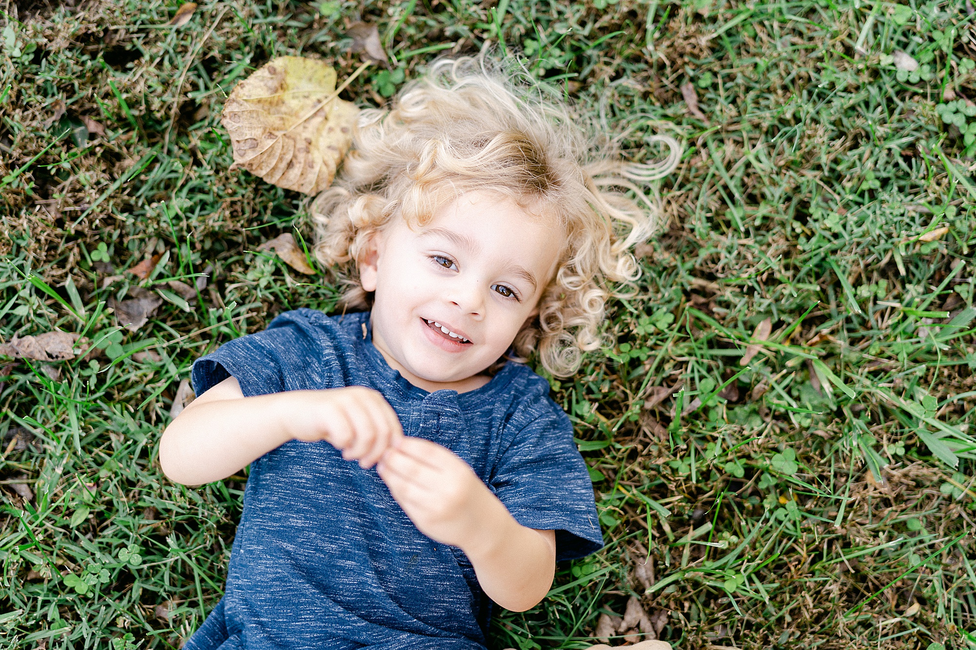 little boy lays in grass during Nashville Family Session