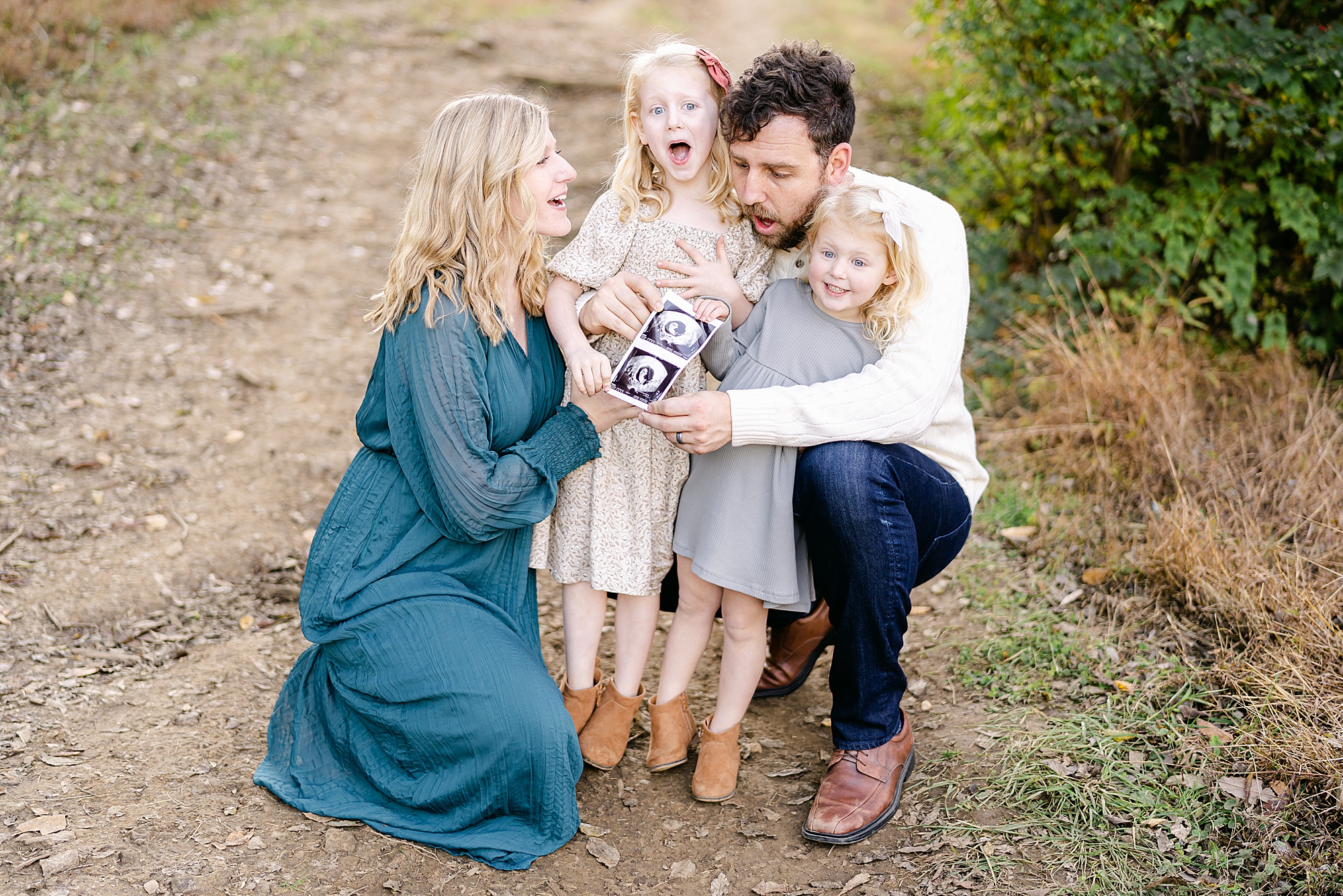 family make baby announcement during Brentwood family photo session