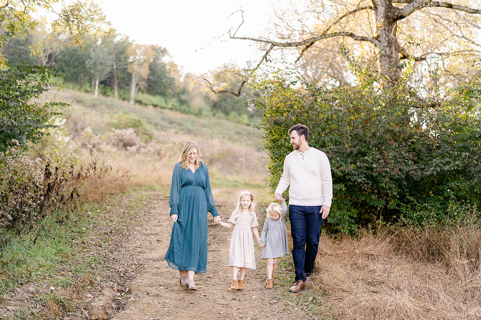 mom and dad walk with their two daughters during Brentwood Tennessee Family Session